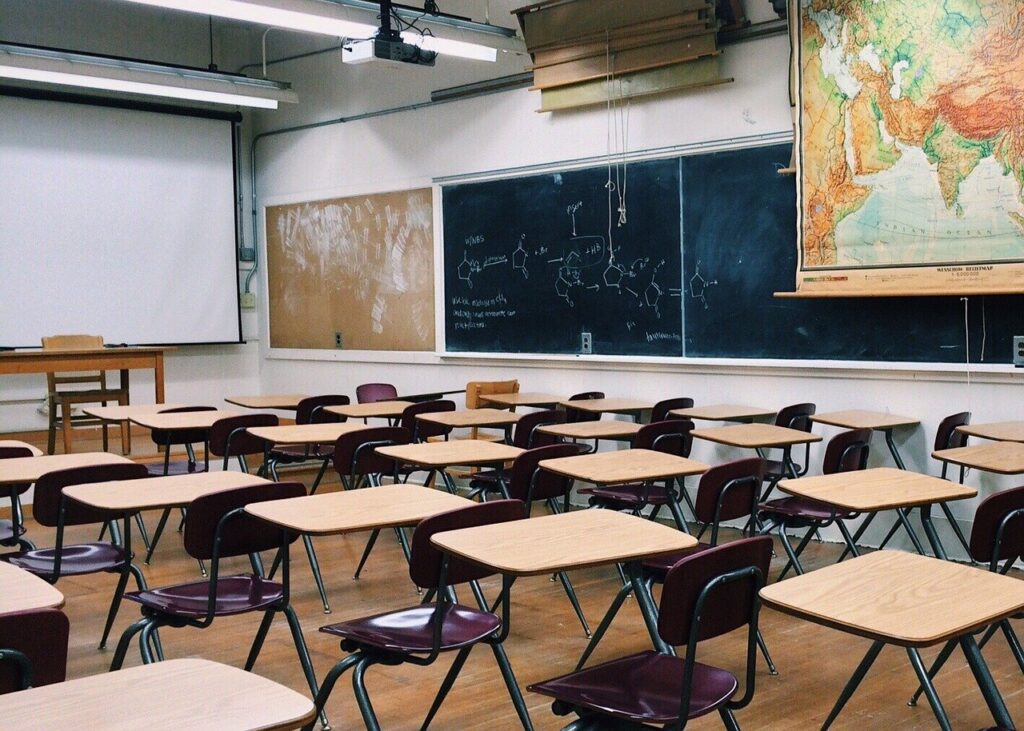 a classroom setting with desks and chalkboards in 2021 article about school cleaning service